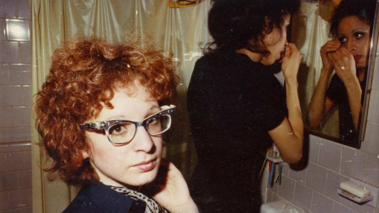 a woman with glasses and curly hair